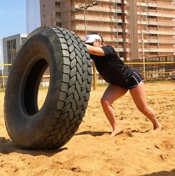 Naiara Azevedo levantando pneu enorme