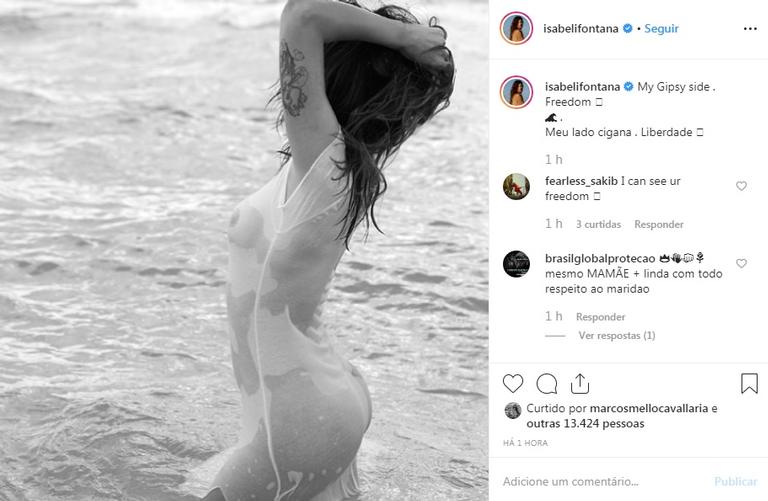 Isabeli Fontana posa vestindo apenas camisetona molhada