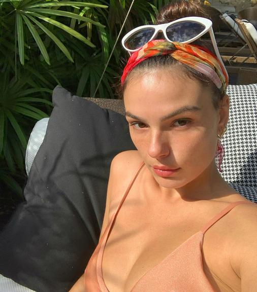 Isis Valverde surge de cara lavada tomando sol