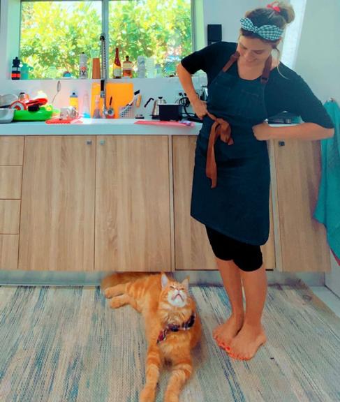 Carolina Dieckmann posa ao lado de seu gato na cozinha