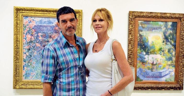 Casal aprecia quadros em museu de arte contemporânea. - City Files