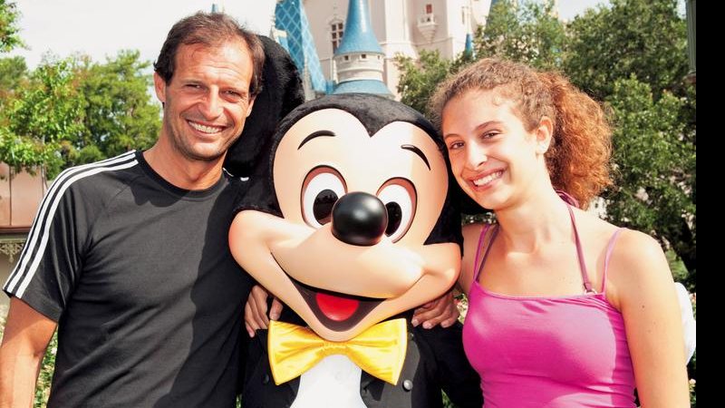 O técnico do Milan, Massimiliano Allegri, divertese com a filha, Valentina, ao lado de boneco do Mickey, no parque da Disney, nos EUA.