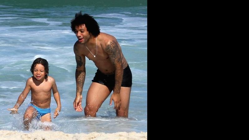 Marcelo Vieira com o filho, Enzo, no mar de Ipanema, no Rio. - Wallace Barbosa/Agnews