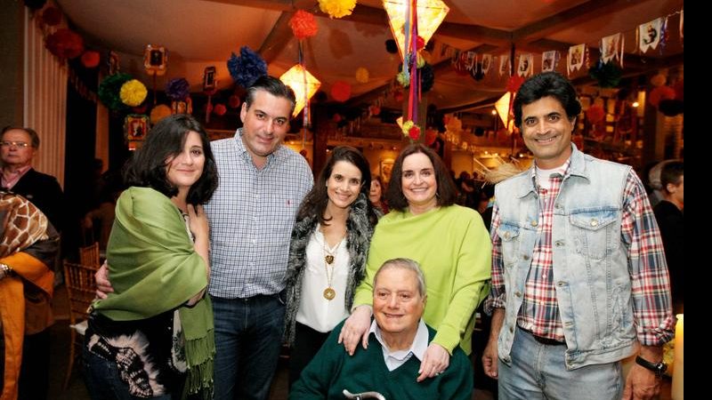 O aniversariante Paulo Tarso Flecha de Lima recebe o carinho dos filhos e da mulher em um arraial nos jardins de sua casa. - Lincoln IFF