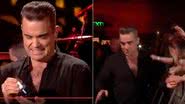 Robbie Williams limpa as mãos com álcool gel após tocar em fãs - YouTube/Reprodução