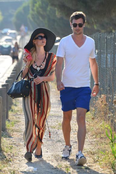 Com um vestido florido, Paris ainda caminhou na areia da praia ao lado de um belo rapaz. Segundo a Grosby Group, o moço é um amigo da socialite