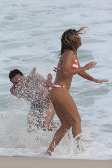 Flávia Alessandra e Rodrigo Lombardi gravam cenas de amor na praia