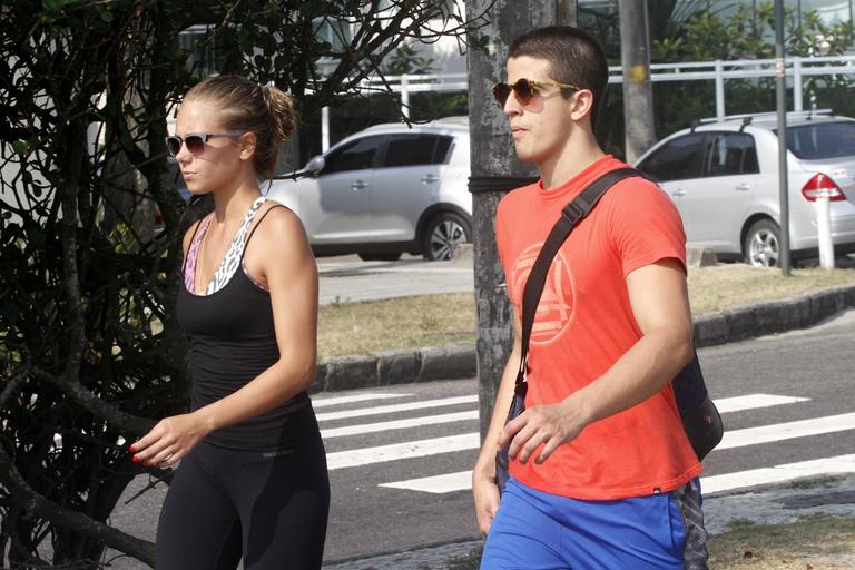 Enzo Celulari corre com a namorada em orla da praia no Rio