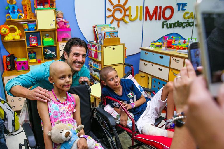 Reynaldo Gianecchini visita crianças, distribui presentes e tira fotos no hospital do GRAAC