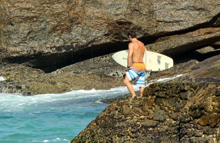 Flávio Canto exibe tanquinho em dia de surfe na praia