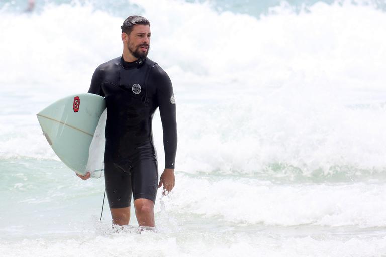 Cauã Reymond e José Loreto surfam em praias cariocas