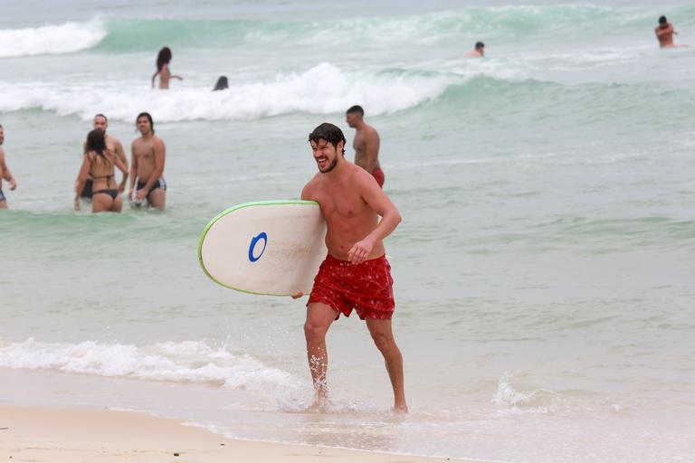 Cauã Reymond e José Loreto surfam em praias cariocas