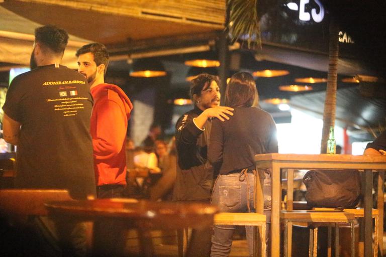 Sem máscara, Douglas Sampaio é flagrado com amigos em bar