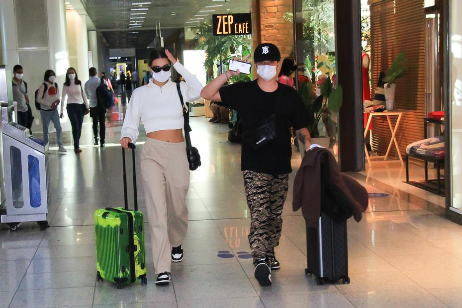 Sasha Menegehel e João Figueiredo de tênis iguais em aeroporto