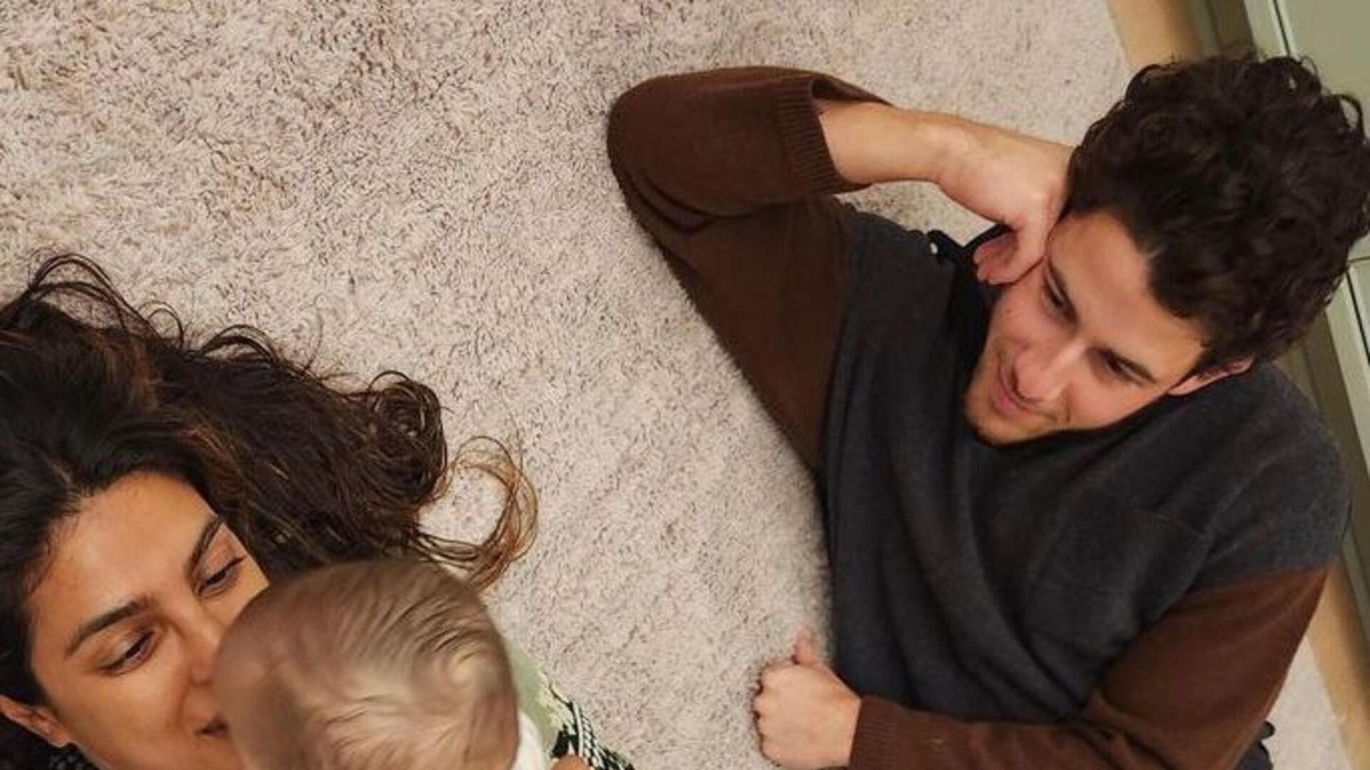 Pais de primeira viagem, Nick Jonas e Priyanka Chopra surgem fazendo carinho na filha em foto rara