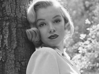 Com a camisa abotoada até o pescoço e uma expressão inocente, Marilyn em ensaio inédito