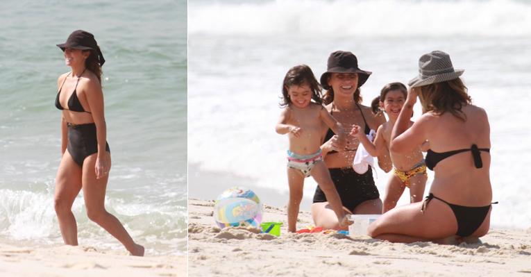 Giovanna Antonelli escolhe biquíni comportado em dia de praia com as gêmeas