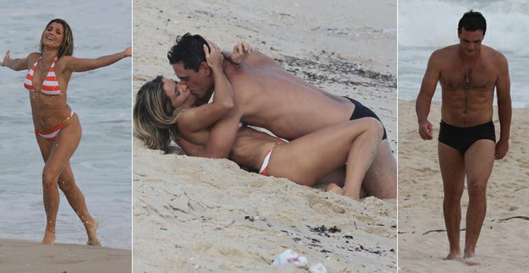 Flávia Alessandra e Rodrigo Lombardi gravam cena de amor na praia