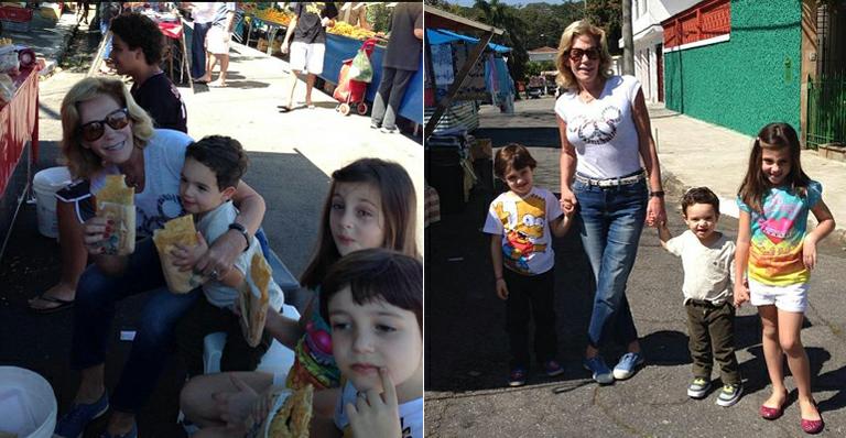 Regina Manssur, participante do ‘Mulheres Ricas’, come pastel em feira de São Paulo