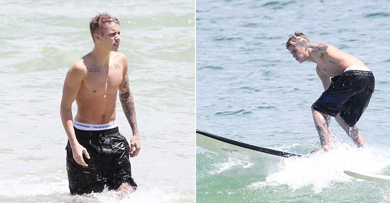 Exibindo boa forma no mar, Justin Bieber aprende a surfar na Austrália