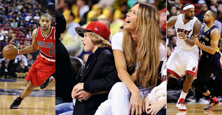 Elle Macpherson leva o filho para assistir uma partida de basquete