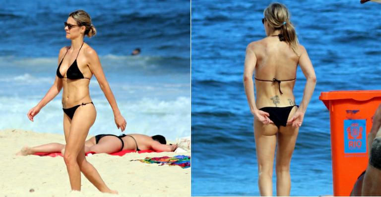 Fernanda Lima leva tombo em jogo de vôlei e mostra boa forma na praia