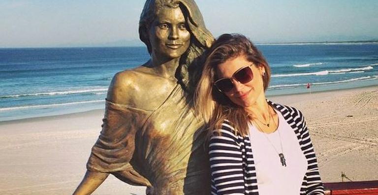 Flávia Alessandra posa ao lado de sua estátua de bronze em Arraial do Cabo