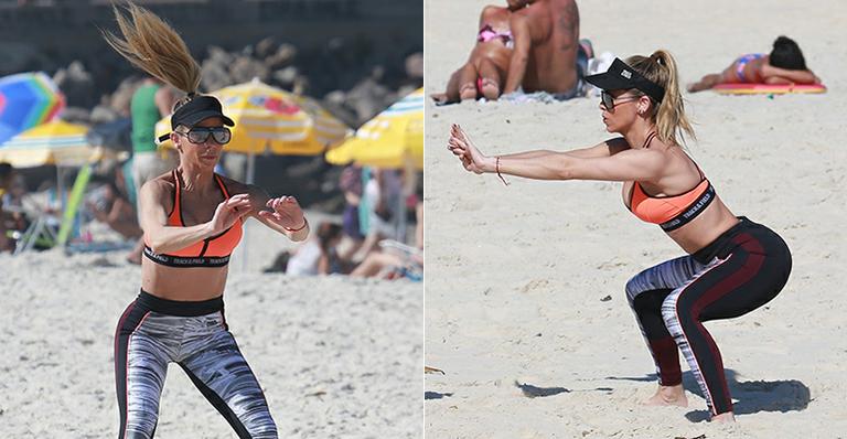 Aos 41, Danielle Winits exibe barriga trincada em dia de exercícios na areia