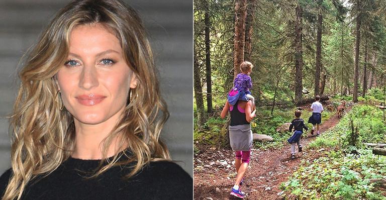Carregando a caçula nas costas, Gisele Bündchen faz trilha com os filhos