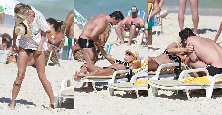 Adriane Galisteu troca beijos e carinhos com o marido Alexandre Iódice em praia no Rio