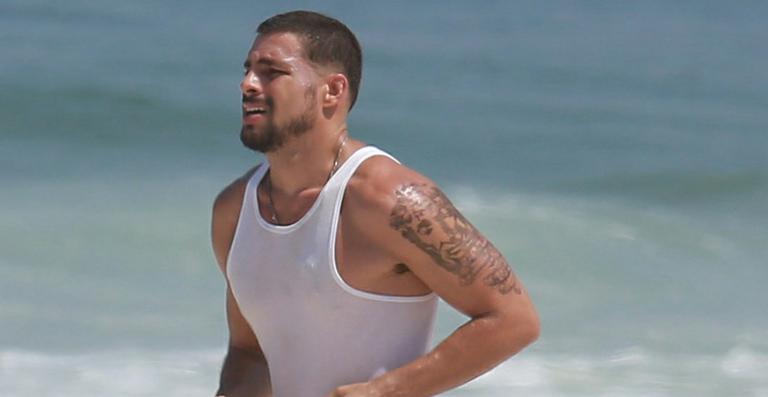 Cauã Reymond se exercita na praia da Barra da Tijuca, no Rio