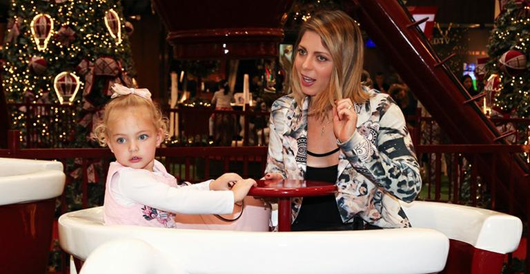 Sheila Mello leva a filha para receber Papai Noel em evento natalino
