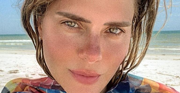 Com pose inusitada, Carolina Dieckmann se alonga durante viagem de carro